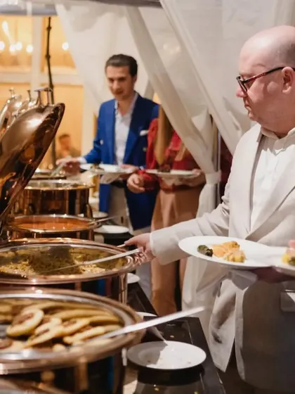 A guest enjoying the buffet during a special event. We can provide various service styles, including buffet setups for larger gatherings.