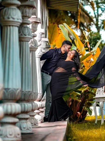 A creative pre-wedding shot with a flowing black saree. The movement of the fabric adds a dynamic and artistic element to the photograph.