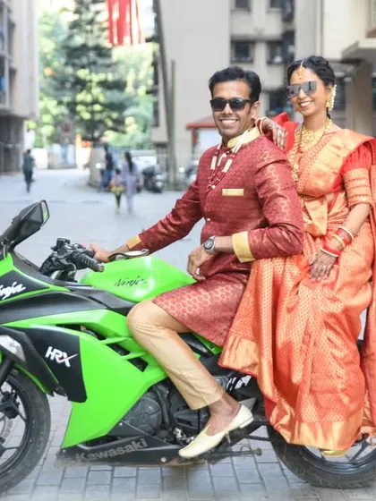 Another great shot of the cool couple and their bike, capturing their happy and confident smiles.