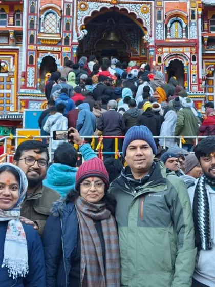 **Memories at Badrinath.** A family poses for a picture, capturing their shared spiritual journey at the vibrant Badrinath temple.
