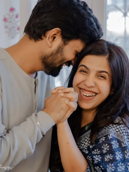 Holding hands and sharing a laugh. The essence of a happy, comfortable love.