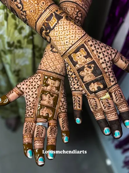 The palms of the baby shower mehendi, featuring a playful design with a family of cute elephants.