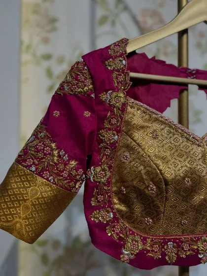 Another angle of the magenta and gold blouse, highlighting the unique combination of fabrics and embroidery.