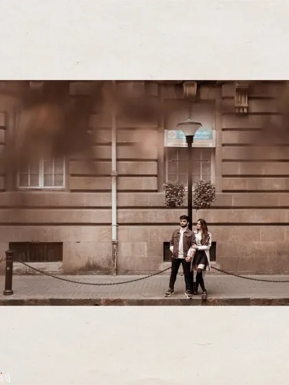 A wide, atmospheric shot of the couple on a quiet Mumbai street, creating a cinematic feel.