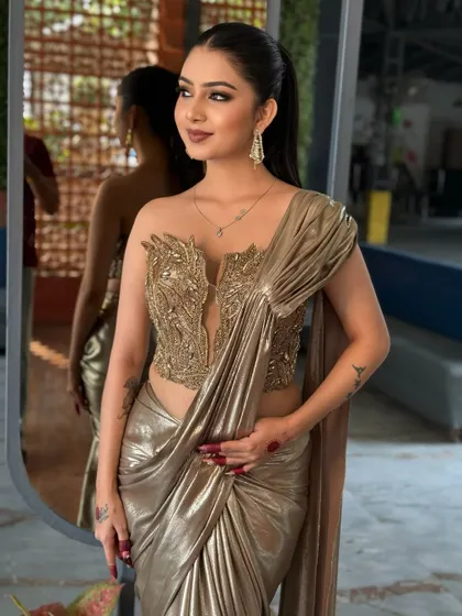 Another angle of the golden saree look, showing its unique draping.