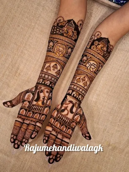 A grand design with peacocks, elephants, and religious symbols like the 'Khanda' and 'Ek Onkar'. This is a great example of a personalized traditional design.
