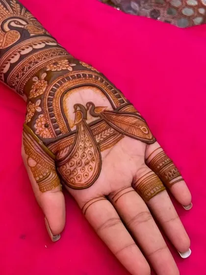 A close-up of the palm featuring two peacocks inside a decorative arch. This is a classic and beloved design for festive occasions.