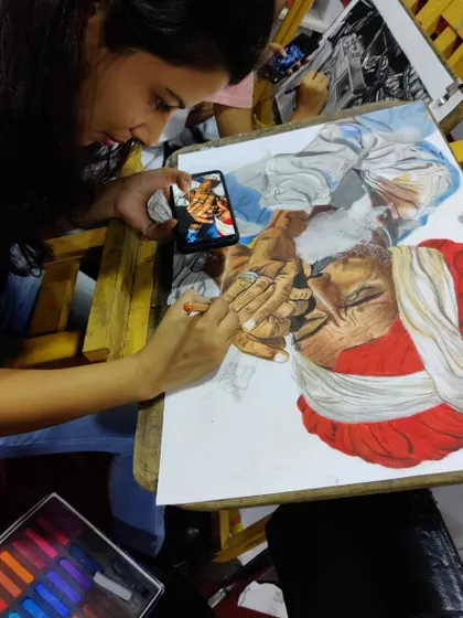 A glimpse into my method for creating portraits. I use a reference photo on my phone to guide me, ensuring I capture all the important details and likeness of the subject.