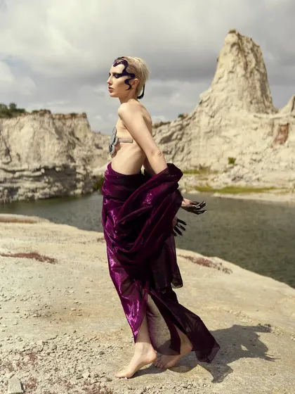 The movement of the purple fabric complements the flow of the sculpted hair in this shot from the 'Siren' series.