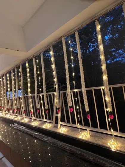As evening fell, the balcony came alive. We added delicate fairy lights to the traditional floral strings, creating a magical and warm ambiance for the family to enjoy their new outdoor space.