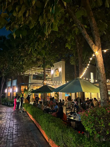 The cafe and patio look magical at night, with string lights creating a warm and inviting atmosphere for dinner and drinks.