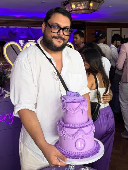 It’s me, the Chubby Baker, with a mini version of a tiered cake we made for a corporate celebration. Being a part of a brand's success story is always a pleasure, and it’s great to put a face to the cakes you love.