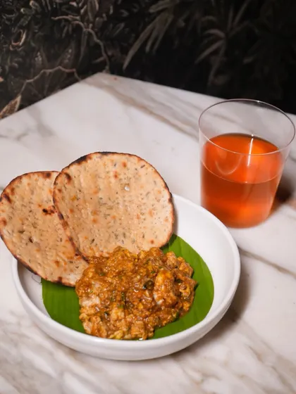 The Bheja Fry and Khasta Roti, paired with a refreshing cocktail. A classic combination that needs no introduction, only a good appetite.