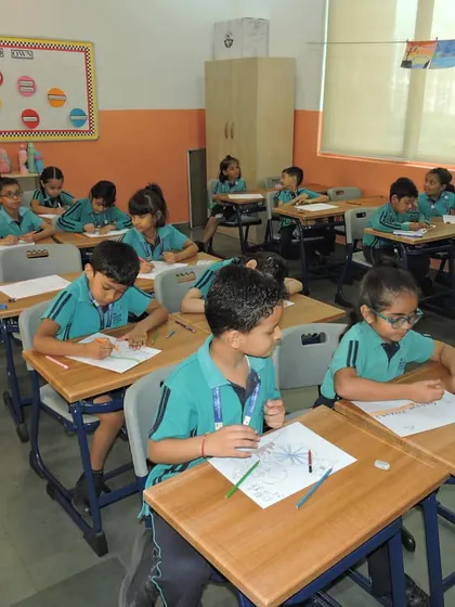 Another view of the classroom during the poster-making activity, showing the students' deep concentration.