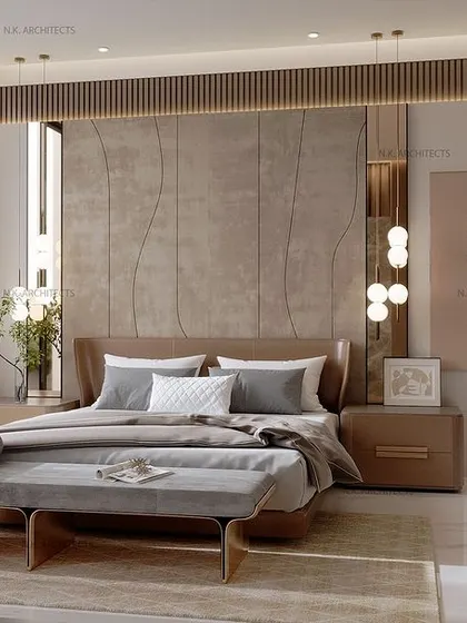 This modern bedroom exudes luxury through its details. The plush, upholstered headboard is complemented by chic pendant lights and a curved wall with wood paneling, creating a sophisticated and meticulously designed space.