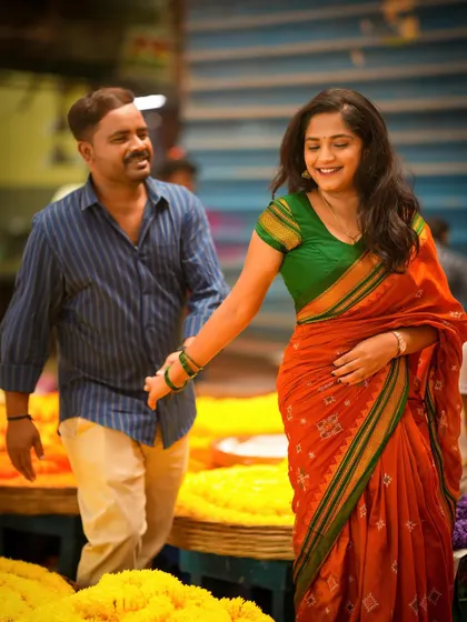 A natural and joyful shot of a couple walking through a market, their smiles telling the story.