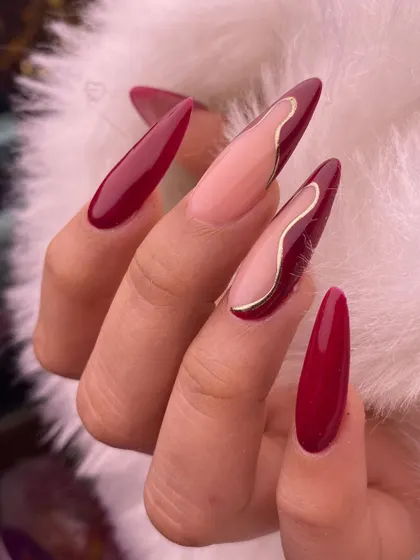 A final, crisp shot of the red and gold abstract nails, highlighting the clean lines and glossy finish.