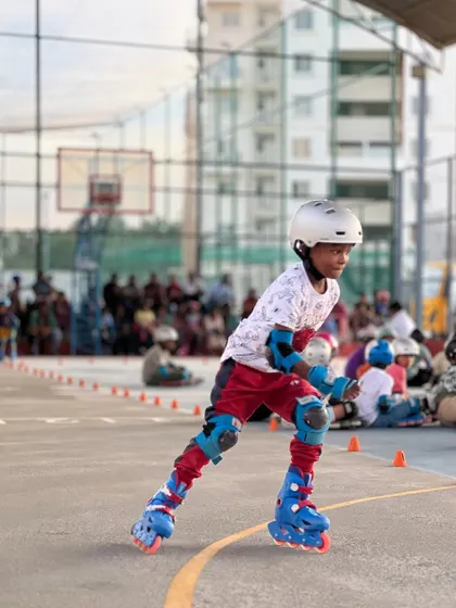 A young skater leans into the turn with perfect form. We focus on teaching the fundamentals of roller skating, like how to properly navigate corners, which is essential for both safety and speed.