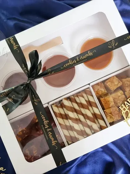 My Ultimate Dipping Box for Rakshabandhan. It includes brownie bites, wafer rolls, and tea cake bites with three delicious dips: Chocolate Ganache, Nutella, and Salted Caramel.