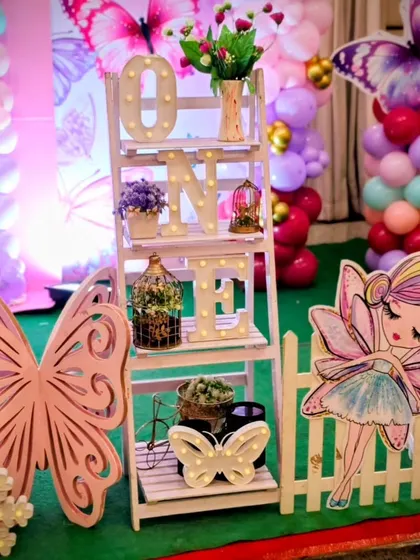 A detail shot of the decor, including a fairy cutout and a light-up 'ONE' shelf.