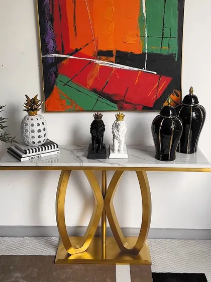 A third styling option for the console table, this time with a more balanced and symmetrical arrangement of black and white showpieces for a classic and harmonious look.