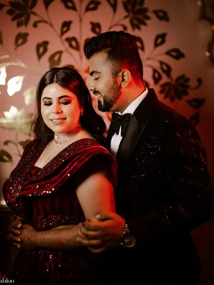 An intimate, warmly lit portrait of Jatin and Muskan. This close-up shot captures their connection and the romantic ambiance of their Sangeet night.
