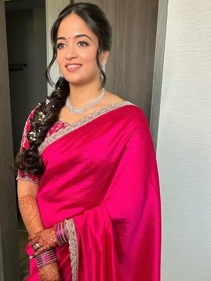 The full look, showcasing the beautiful drape of the saree and the elegant hairstyle.