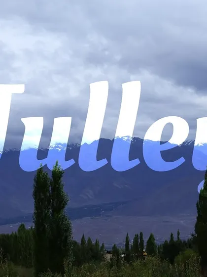 "Julley," the traditional Ladakhi greeting, set against a backdrop of the mountains. It's the first word you'll learn and use on our trips.