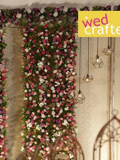 A detail shot of the indoor decor. This shows the vibrant floral panels next to modern geometric hanging lights, a beautiful blend of traditional and contemporary design elements.