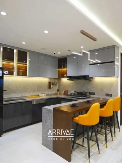 A bold and contemporary kitchen with gray cabinets and a striking yellow breakfast bar. This design is perfect for entertaining and adds a vibrant energy to the home.
