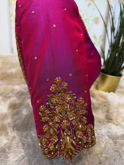 A detailed shot of the embroidery on the sleeve cuff, showcasing the intricate floral patterns.