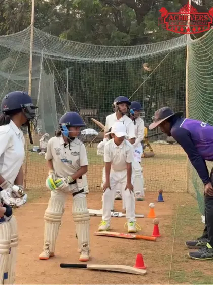 A group of young girls in full gear, listening intently to their coach's instructions. We focus on building strong technical skills from the very beginning.