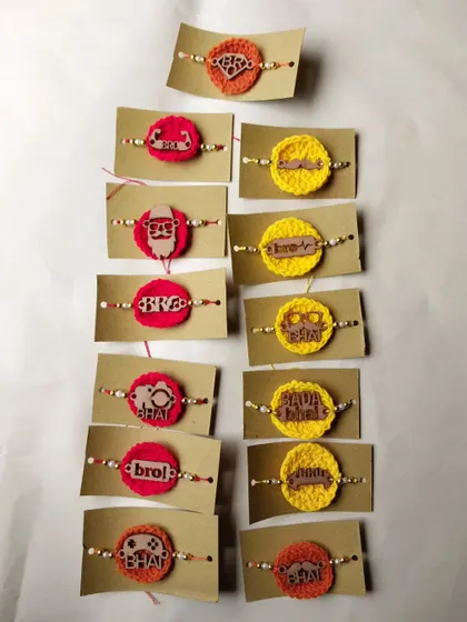 A collection of my crochet MDF rakhis, featuring fun tags like 'Bro', 'Bhai', and 'Swag Wala Bhai'. These are very popular for their quirky style.