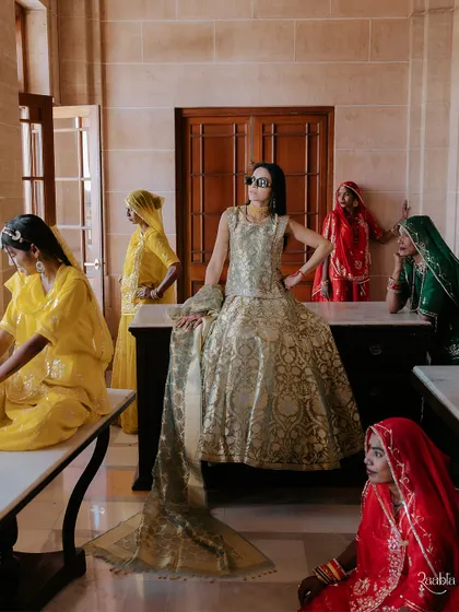 A cool, modern bride posing with her "local tribe," a fun and fashionable shot from the Mehendi celebrations.