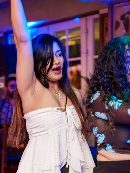 Hands up for a favorite track. A guest dancing with pure abandon, embodying the spirit of VIBE CHECK.