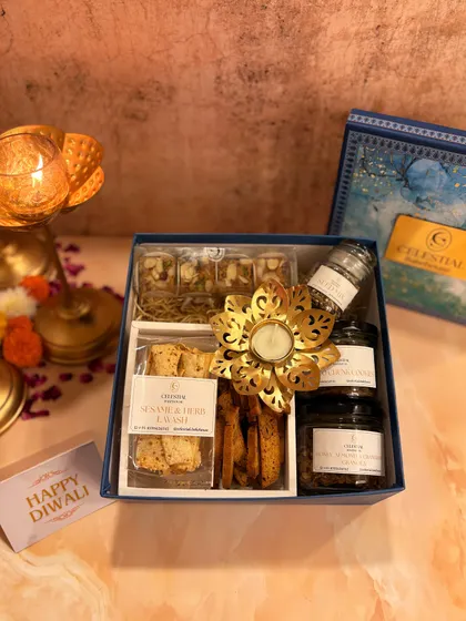 Our 'Illuminating Indulgence' box includes a beautiful metallic flower diya to light up your festive celebrations.