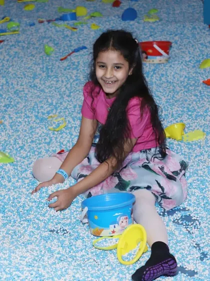 A big smile from inside our pellet pit! It's a favorite spot for imaginative and sensory play.