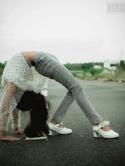 This photo showcases a young gymnast's flexibility with a backbend on an open road. It's a unique and dynamic portrait that highlights a child's talents and passions.