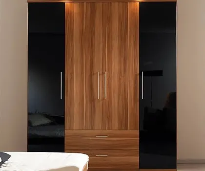 A modern wardrobe design that combines natural wood with black glass panels. The sleek silver handles and built-in drawers offer a perfect blend of style and functionality.