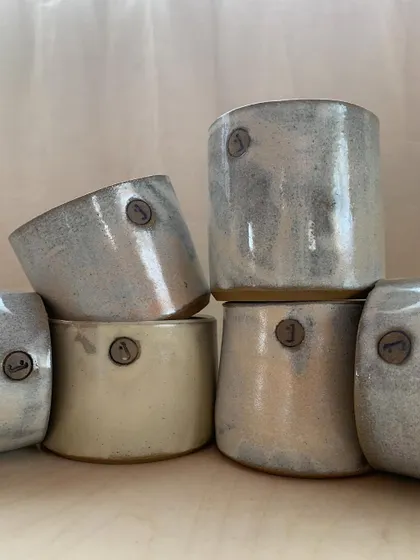 These cups were made especially for my studio, stamped with our logo. They hold our tools and brushes, and seeing them every day feels like home.