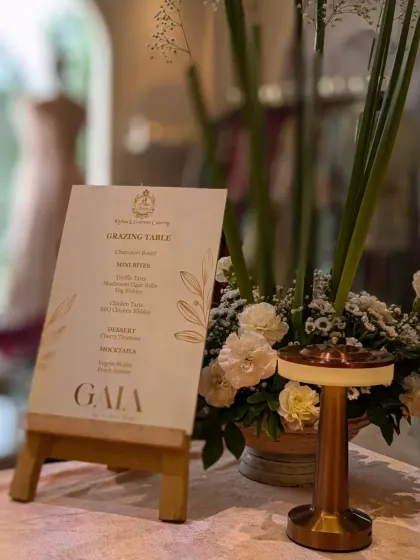 A close-up of the custom menu I designed for the Gaia by Archie brand event. The elegant menu is displayed next to a beautiful floral arrangement, adding a personalized and sophisticated touch to the grazing table.