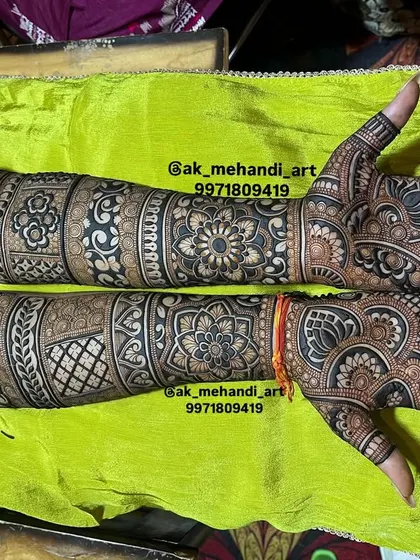 This design shows a beautiful contrast between the dark henna paste and the skin, with patterns covering the hands and arms completely.