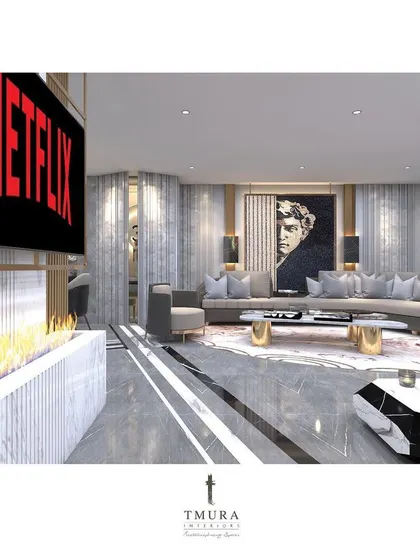 We integrate technology seamlessly into our designs. Here, a modern fireplace is built into a marble-clad media wall, providing warmth and ambiance without disrupting the clean lines of the contemporary living space.