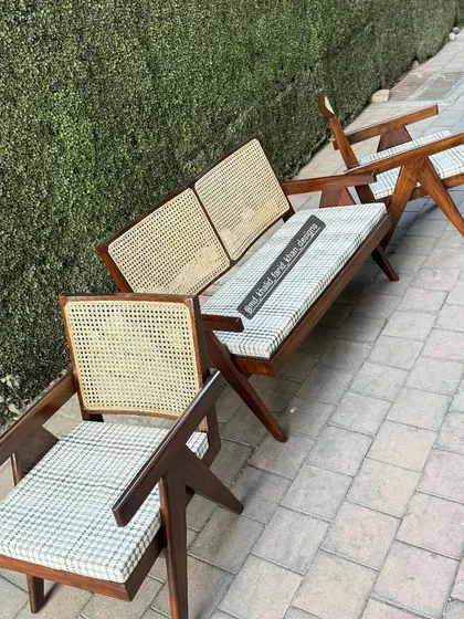 An angled view showing the profile of both the armchair and the two-seater bench.