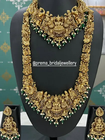 An intricate antique bridal set featuring dancing goddess figures and green bead accents.