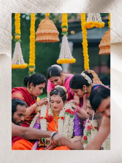 The bride being adorned by her family during the ceremony, a moment of love and care.
