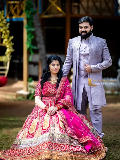 For a softer, contemporary traditional look, this couple chose a pink embroidered lehenga paired with a light purple sherwani. The complementary pastel tones work beautifully together for daytime photoshoots in garden settings.