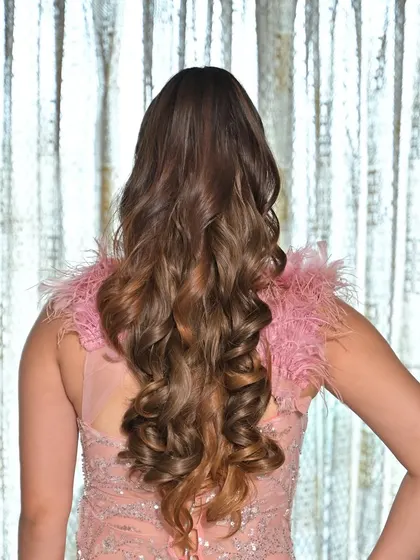 Bouncy, voluminous curls are perfect for a cocktail party or reception. This style adds so much glamour and movement, especially for long hair.