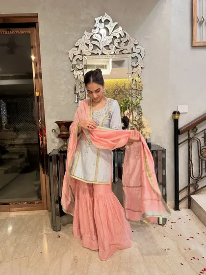 Adjusting my dupatta in the sharara set. This shows the practical yet beautiful side of wearing traditional Indian outfits.