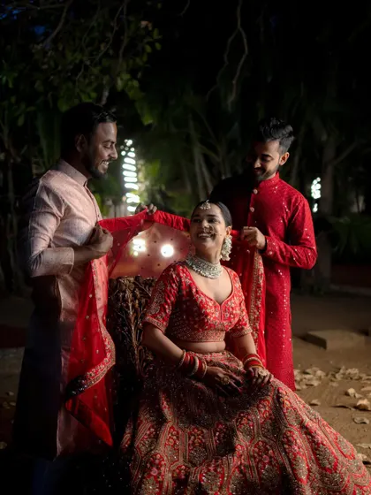 A happy moment as the bride gets her veil placed by her loved ones. Her joyful smile lights up this candid getting-ready shot.